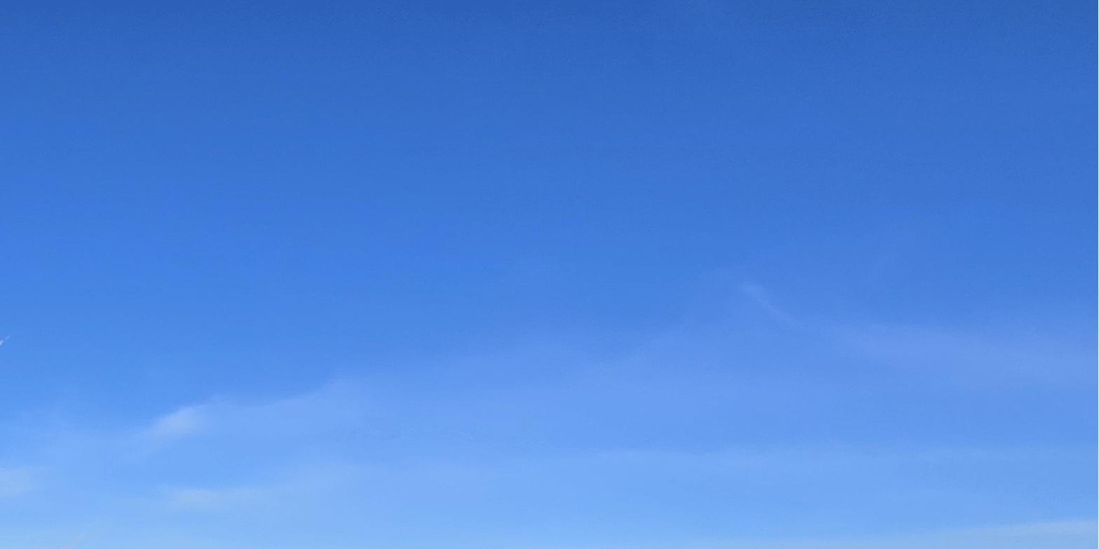 Open blue sky with faint wisps of cloud