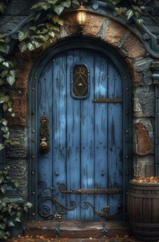 A weathered blue arched door, framed with ivy